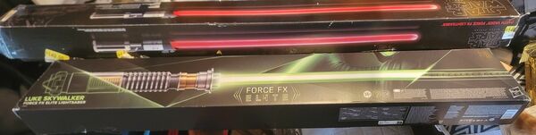 Two Star Wars Dark Lightsabers-- one used Red, the other Green, new open box.